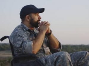 Soldier in uniform sitting in a wheelchair